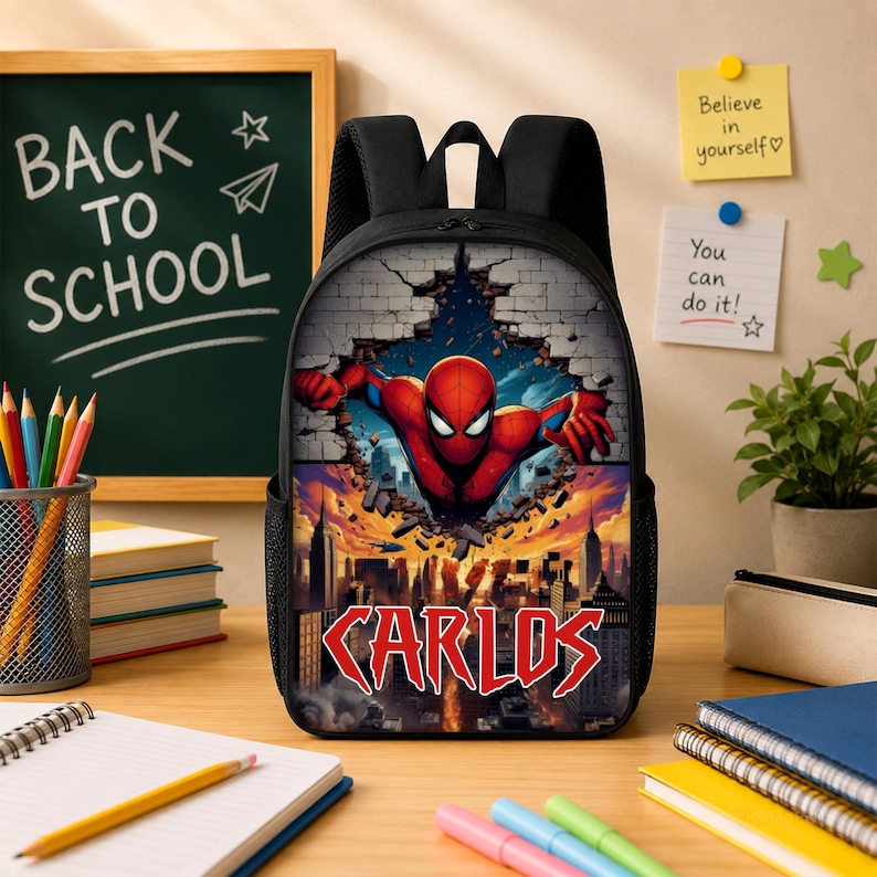 May include: A black backpack featuring a graphic print of a red and blue superhero bursting through a brick wall above a city skyline. The name CARLOS is printed in large red letters at the bottom of the design. The bag has black straps and mesh sides.
