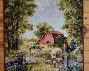 May include: A quilted wall hanging featuring a red barn with a white star on the side, surrounded by green trees and a blue sky. In the foreground, there are white pigs, a rooster, and a cow with a calf.