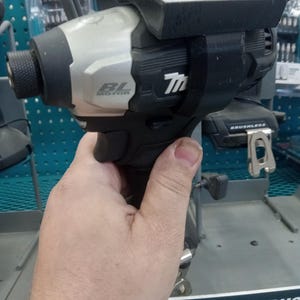 May include: A black and silver cordless drill with a brushless motor. The drill has a black and silver handle and a black trigger. The drill is labeled "BL Motor" and "Makita".
