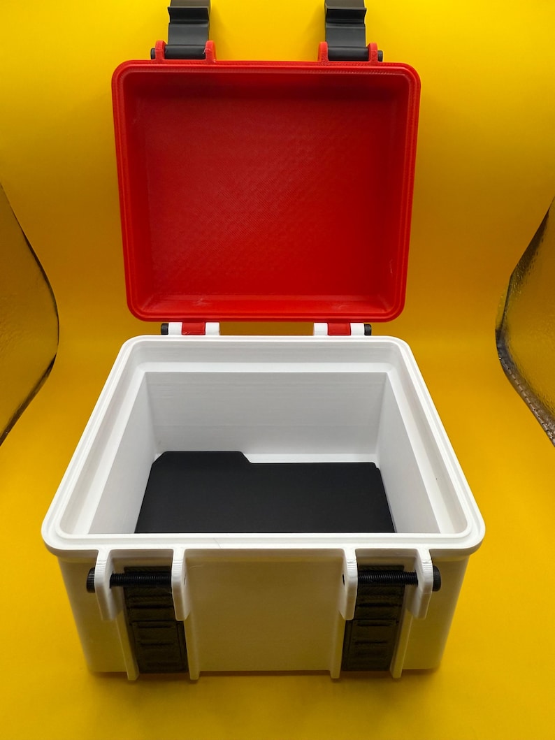 May include: A white plastic storage case with a red lid and black latches. The case is open and the inside is empty.