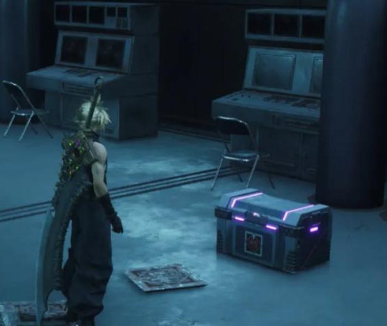 May include: A gray metal chest with a purple glow around the edges. The chest is sitting on a gray floor in a room with a dark gray wall.