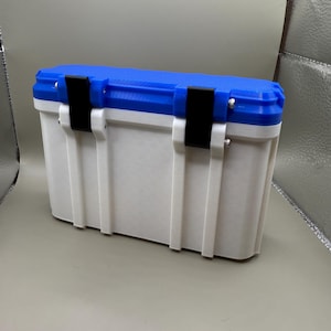 May include: A white and blue plastic storage box with black latches. The box has a textured surface and is closed.