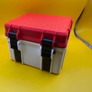 May include: A white and red plastic storage box with black latches and a textured lid.