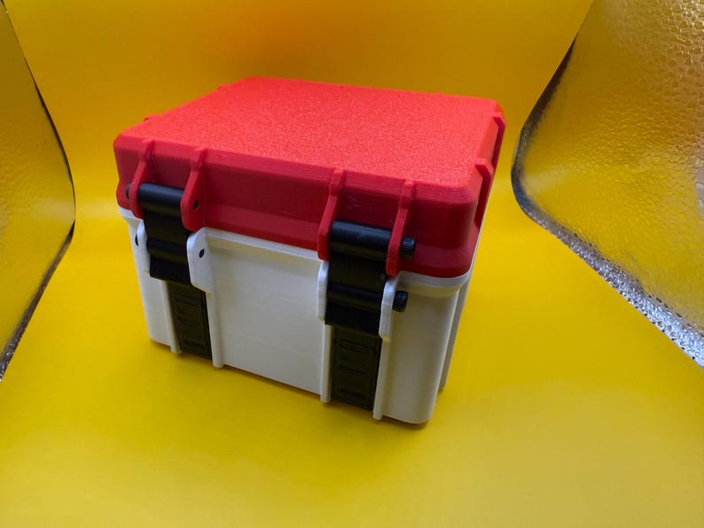 May include: A white and red plastic storage box with black latches and a textured lid.