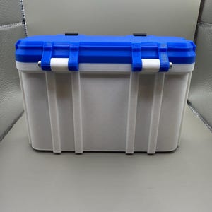 May include: A white and blue plastic storage container with a latching lid. The container is rectangular in shape and made from durable plastic.