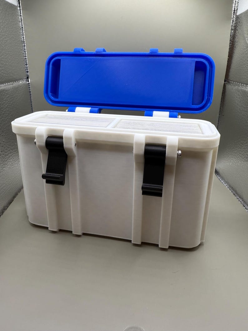 May include: A white plastic storage box with a blue lid. The box has two black latches on each side and a white interior.