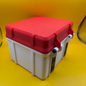 May include: A white and red plastic storage box with a textured lid. The box has a latch on the side and is closed.