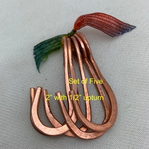 May include: Set of five copper hooks, each measuring 2 inches long with a 1/2 inch upturn. The hooks are arranged in a fan shape.