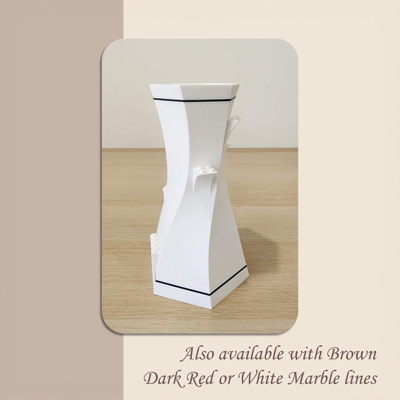 May include: White ceramic vase with a geometric design and black trim. Also available with brown, dark red, or white marble lines.