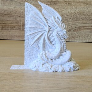 Side-facing white dragon bookend showing full sculpted dragon detail