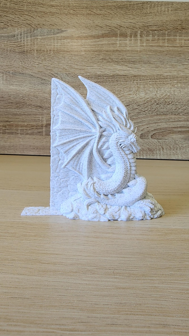 Side-facing white dragon bookend showing full sculpted dragon detail