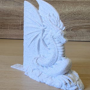 White Majestic Dragon Bookend angled to show detail on wings and base