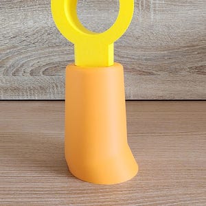 Orange Minifig-Inspired Controller Stand with yellow claw hand displayed on tabletop