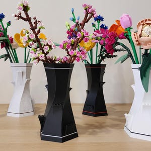 May include: Five different vases with various flowers in them. The vases are all different shapes and sizes. The flowers are all different colors and types. The vases are arranged in a row on a wooden table.