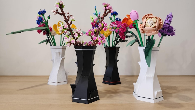 May include: Five different vases with various flowers in them. The vases are all different shapes and sizes. The flowers are all different colors and types. The vases are arranged in a row on a wooden table.