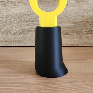 Black Minifig-Inspired Controller Stand on wood grain surface