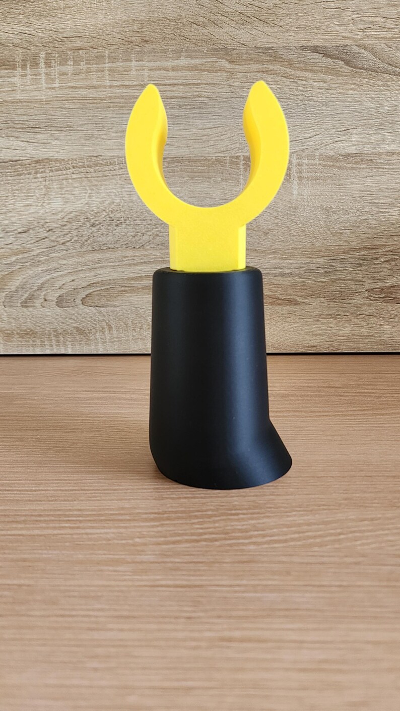 Black Minifig-Inspired Controller Stand on wood grain surface