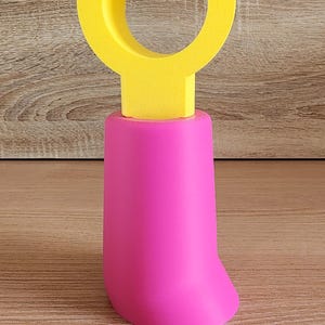 Pink and yellow Minifig-Inspired Controller Stand positioned vertically on wood