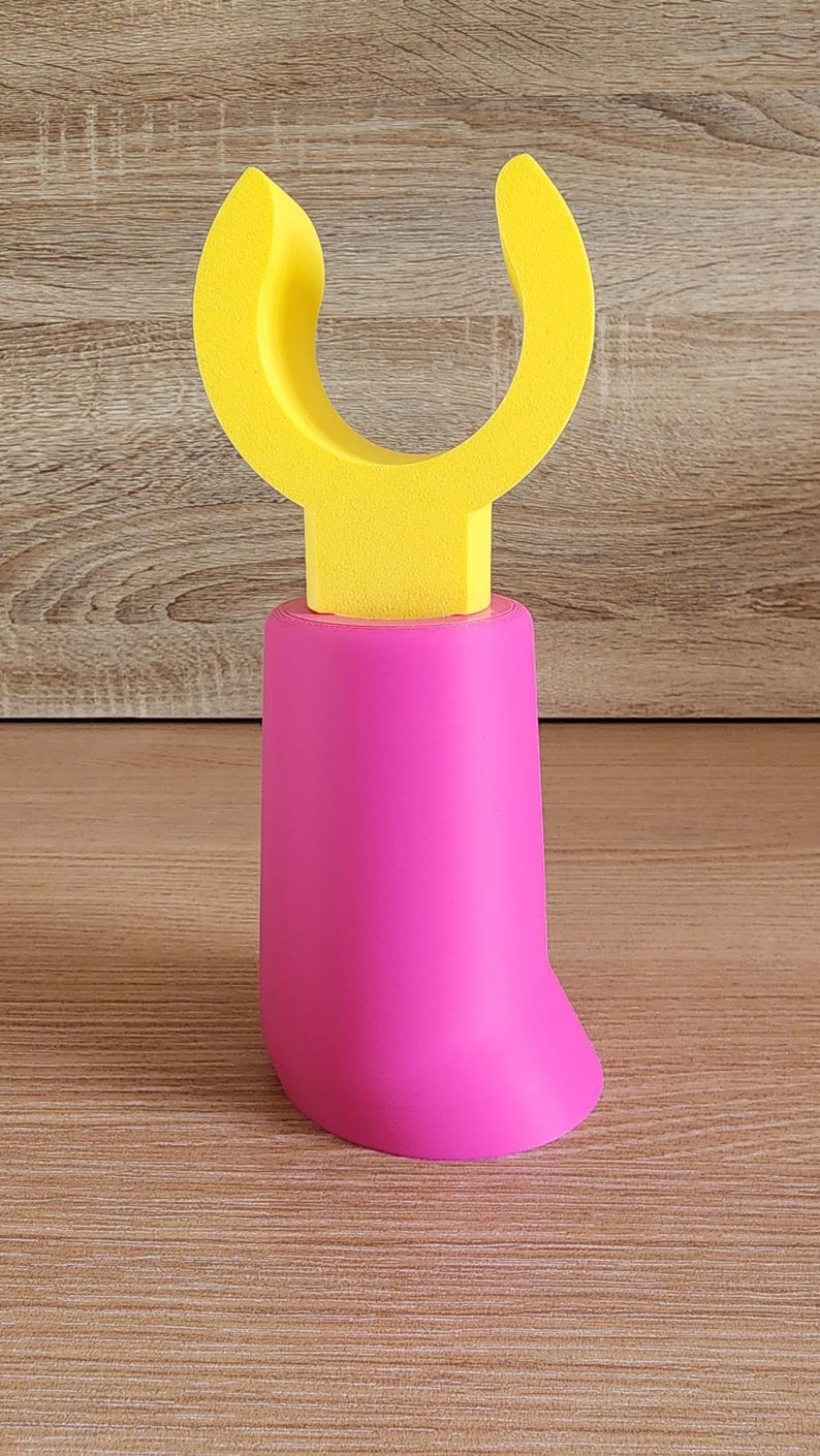 Pink and yellow Minifig-Inspired Controller Stand positioned vertically on wood