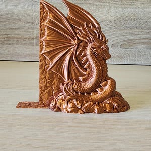 Copper dragon bookend angled to show wing and head detail