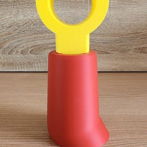 Red and yellow Minifig-Inspired Controller Stand against wooden backdrop