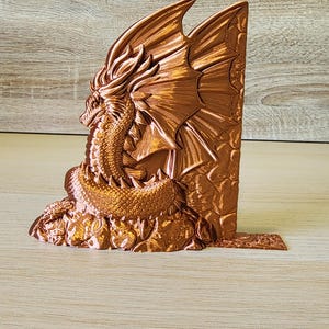 Copper dragon bookend angled to show wing and head detail