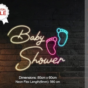 May include: Neon sign with the text "Baby Shower" in white with pink and blue footprints. The sign is 80cm x 60cm and the neon flex length is 560cm.
