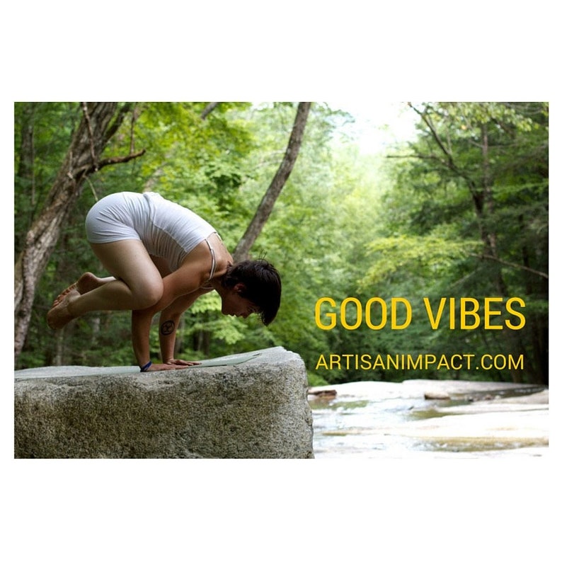 May include: A woman performs a yoga pose on a large rock in a forest setting. The text "GOOD VIBES" and "ARTISANIMpact.com" are visible in the image.