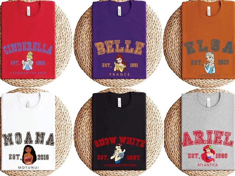 May include: Six different t-shirts featuring Disney princesses. Each shirt has a different princess, name, and established year. The shirts are red, purple, orange, white, black, and gray.