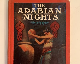 May include: A red hardcover book with the title "THE ARABIAN NIGHTS" in white lettering. The cover features an illustration of a woman in a white tunic and blue pants holding a round object. The background is a dark, ornate room with a stained glass window.