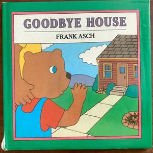 May include: A children's book cover with a brown bear waving goodbye to a red house with a white door. The book title is "Goodbye House" and the author is "Frank Asch".