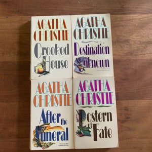 May include: Four paperback books by Agatha Christie. The titles are "Crooked House", "Destination Unknown", "After the Funeral", and "Postern of Fate".