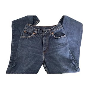 May include: A pair of dark blue denim jeans with a high waist and a straight leg.
