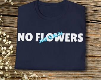 May include: A navy blue t-shirt with the words "NO FLOWERS" printed in white. The word "FLOWERS" is crossed out with a blue design that says "NO RAIN". The shirt is displayed on a wooden surface.