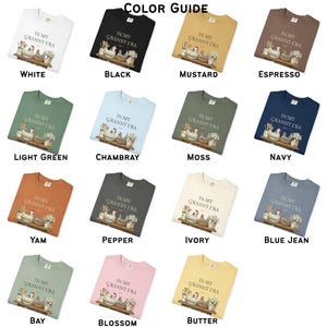 May include: A color guide displays various crewneck sweatshirts. Each sweatshirt features the text "IN MY GRANNY ERA" with a graphic of chickens and kitchen items. Colors include white, black, mustard, espresso, light green, chambray, moss, navy, yam, pepper, ivory, blue jean, bay, blossom, and butter.
