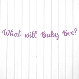 May include: Purple glitter banner with the text "What will Baby Bee?" and two gold glitter bee cutouts.