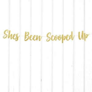 May include: Gold glitter banner with the text "She's Been Scooped Up" and two green ice cream cone cutouts.