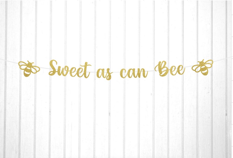 May include: Gold glitter banner with the text "Sweet as can Bee" and two bee cutouts on either end.