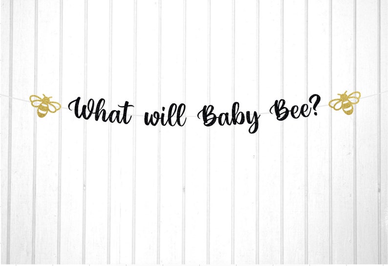 May include: A black and gold gender reveal banner with the text "What will Baby Bee?" and two gold glitter bee cutouts.