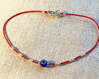 Delicate Red Silk Bracelet with Darker Blue Evil Eye Bead, Tiny Silver Beads and Sterling Silver Clasp