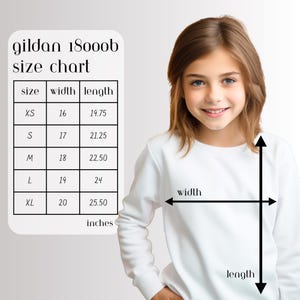 May include: A white sweatshirt with a size chart for Gildan 18000b. The chart shows measurements in inches for sizes XS to XL. The image also shows a person wearing the sweatshirt, with arrows indicating width and length.