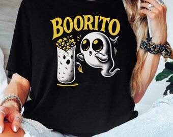May include: Black t-shirt with a yellow and white graphic. The graphic features the word "BOORITO" above a cartoon ghost and a burrito. The ghost has large eyes and is reaching for the burrito. The shirt is a casual style.