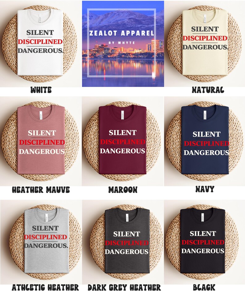 May include: A collection of t-shirts in various colors, including white, natural, heather mauve, maroon, navy, athletic heather, dark grey heather, and black. Each shirt features the text "SILENT DISCIPLINED DANGEROUS" in a bold font.