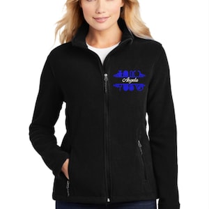 May include: Black fleece jacket with a zipper closure and two zippered pockets. The jacket has a blue embroidered design on the left chest that says "Love" with a heart and "Angela" underneath.