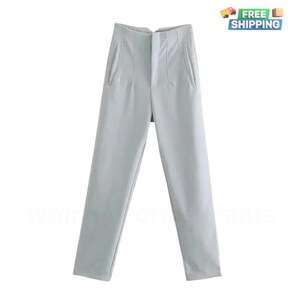 May include: Light blue high-waisted pants with a button and zipper closure. The pants have a slim fit and are made of a smooth fabric.