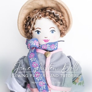 May include: A handmade doll with brown hair, blue eyes, and a pink and blue ribbon around her neck. She is wearing a grey dress with a pink trim and a floral print. The doll is holding a small heart-shaped charm. The doll is wearing a straw hat. The text "Jane Austen Dolls Sewing Pattern and Tutorial" is visible on the image.