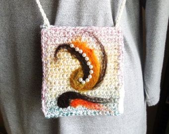 May include: A small crocheted bag with a pink, white, and green color scheme. The bag has a brown and orange yarn design with a string of white pearls.