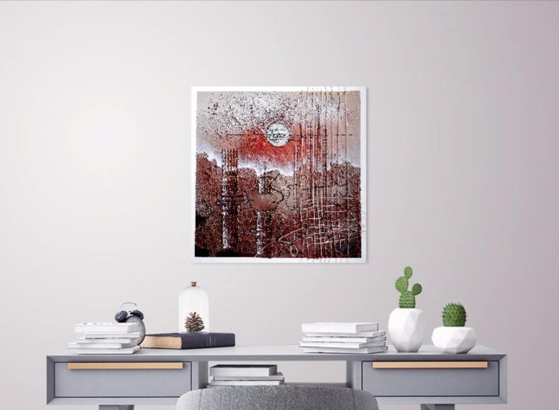 May include: A framed abstract painting with a red, white, and brown color scheme. The painting features a circular shape in the center and a grid-like pattern throughout.