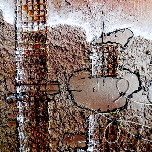 May include: Abstract art painting with a textured brown background. The painting features a grid pattern with rusty metal accents and black and white string details.