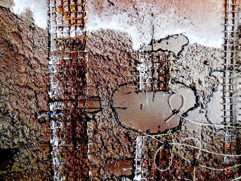 May include: Abstract art painting with a textured brown background. The painting features a grid pattern with rusty metal accents and black and white string details.
